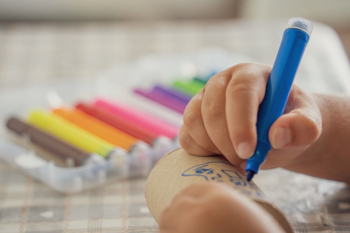 カラーペンで工作をする子どもの手元